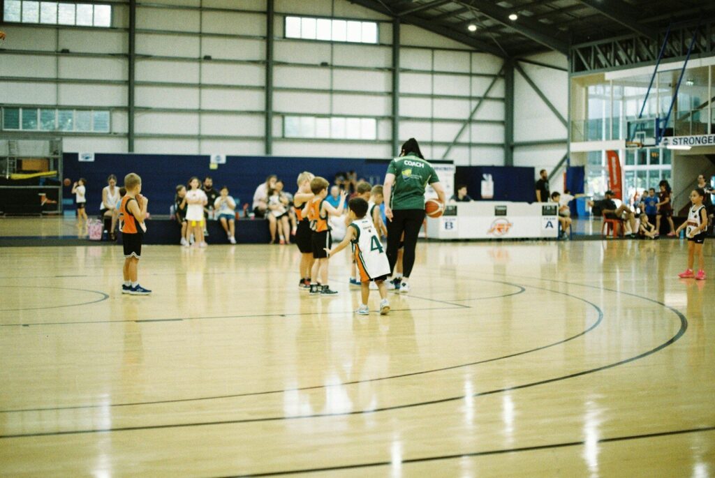Children playing basketball in a gymnasium
