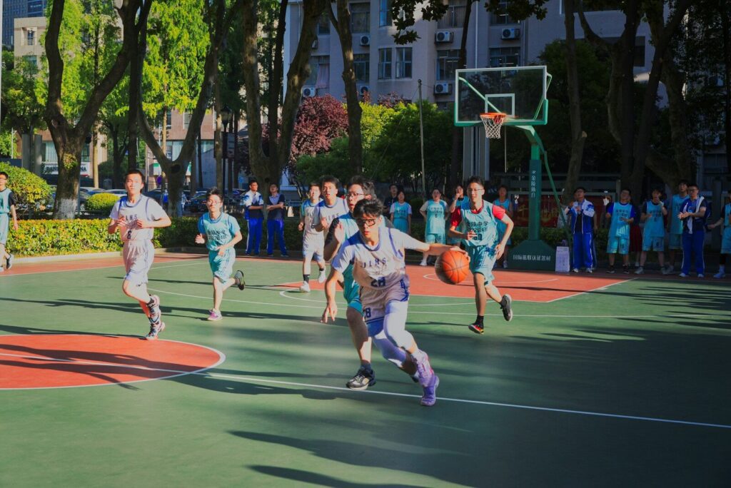 a group of young men playing a game of basketball